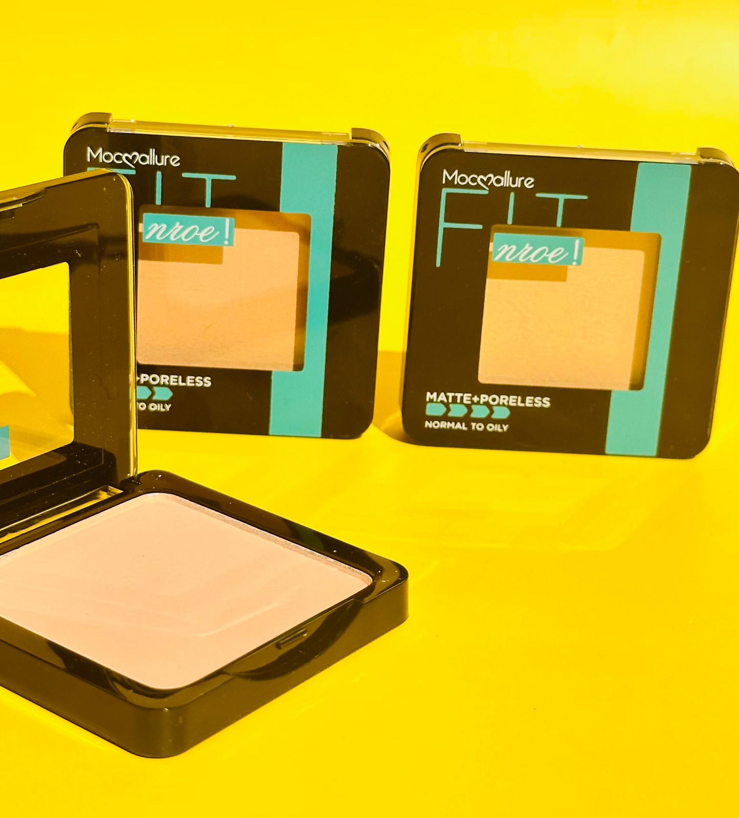Compact face powder in various shades displayed against a yellow background, with packaging visible.